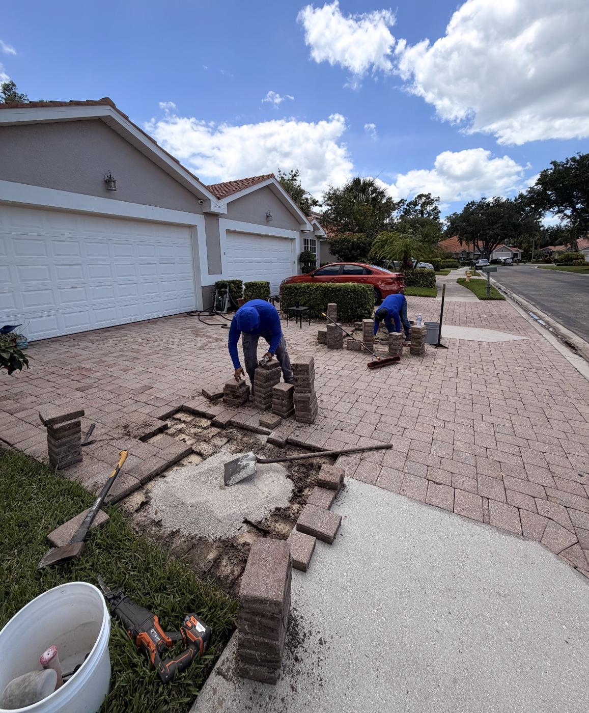 Lucio's Elite Services crew relaying pavers on a Southwest Florida driveway