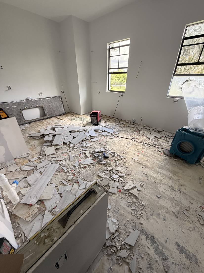 Room mid-demo with broken tile on the floor